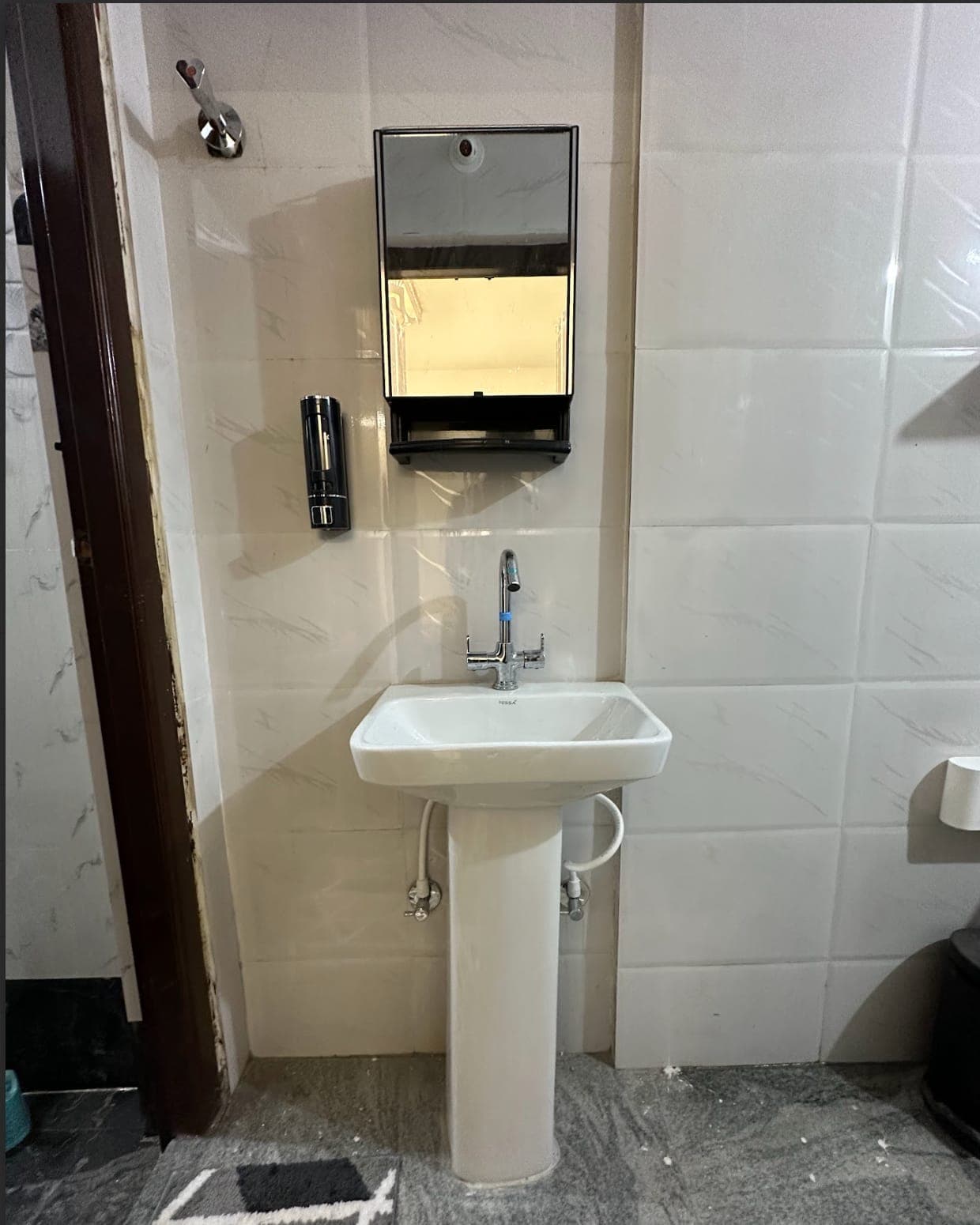 An attached bathroom's washbasin and mirror