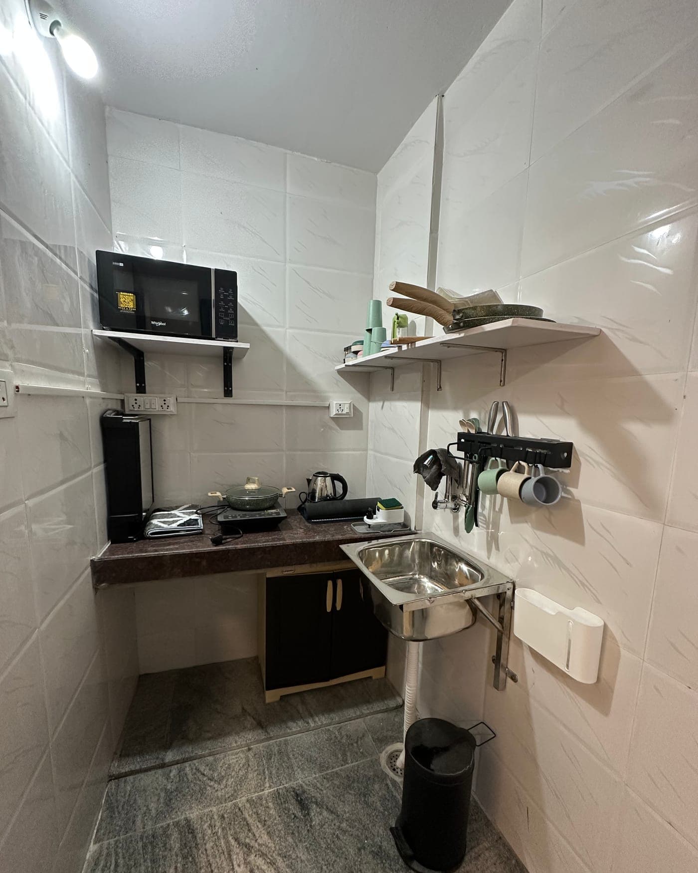 A private kitchenette with induction top, kettle, and microwave