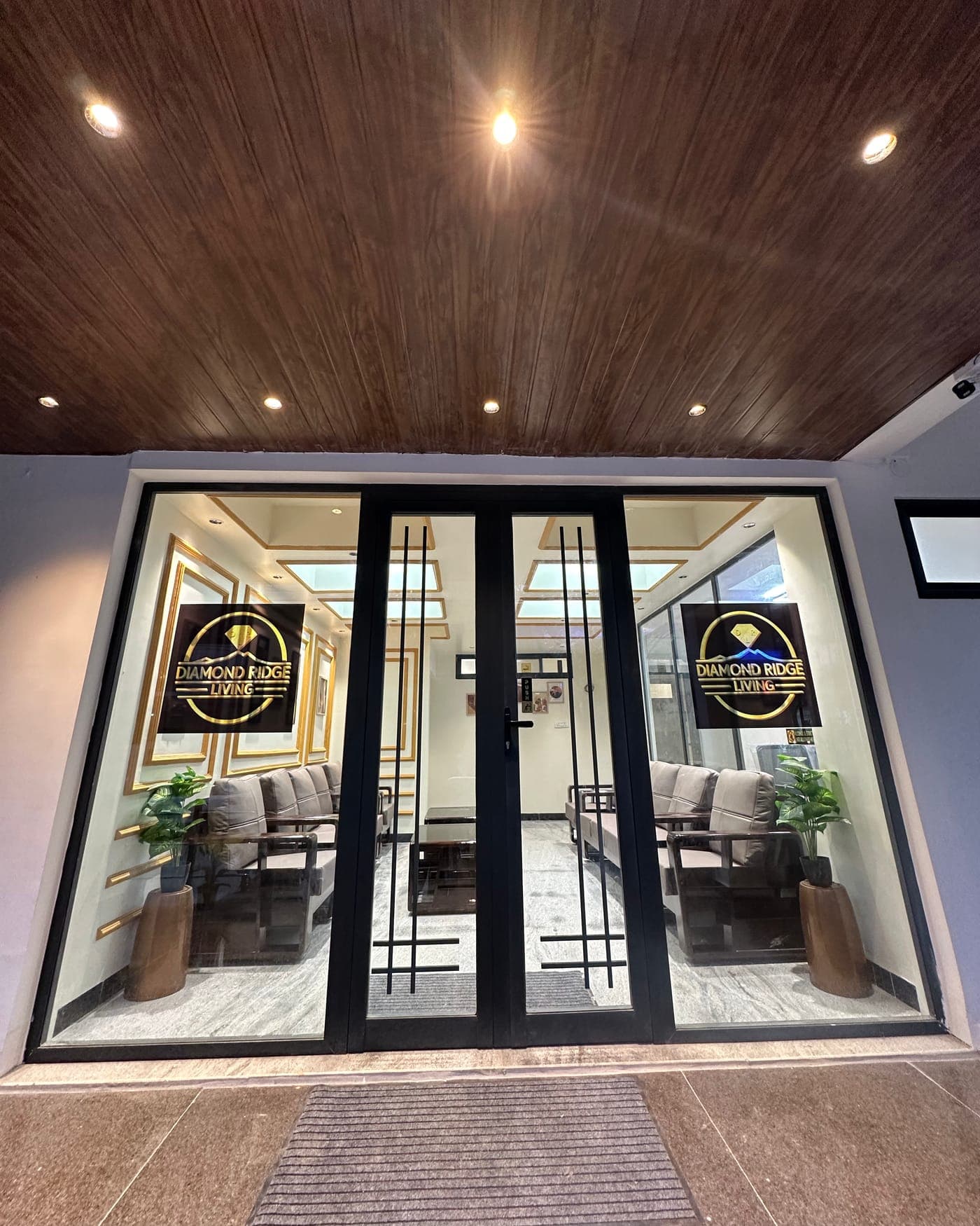 The glass entrance doors with the Diamond Ridge Living sign
