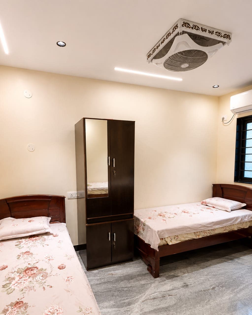 A furnished twin room with wardrobe